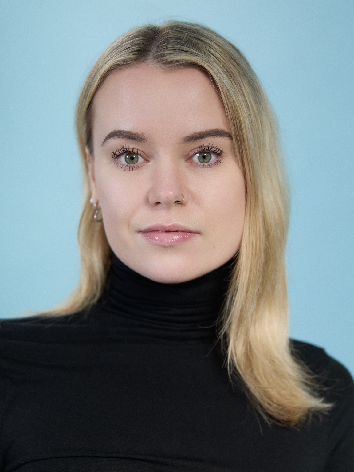 Professional acting headshot of Niamh in a black turtleneck