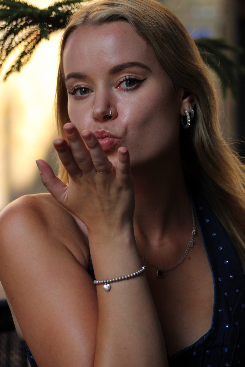 Playful beauty portrait of Niamh blowing a kiss