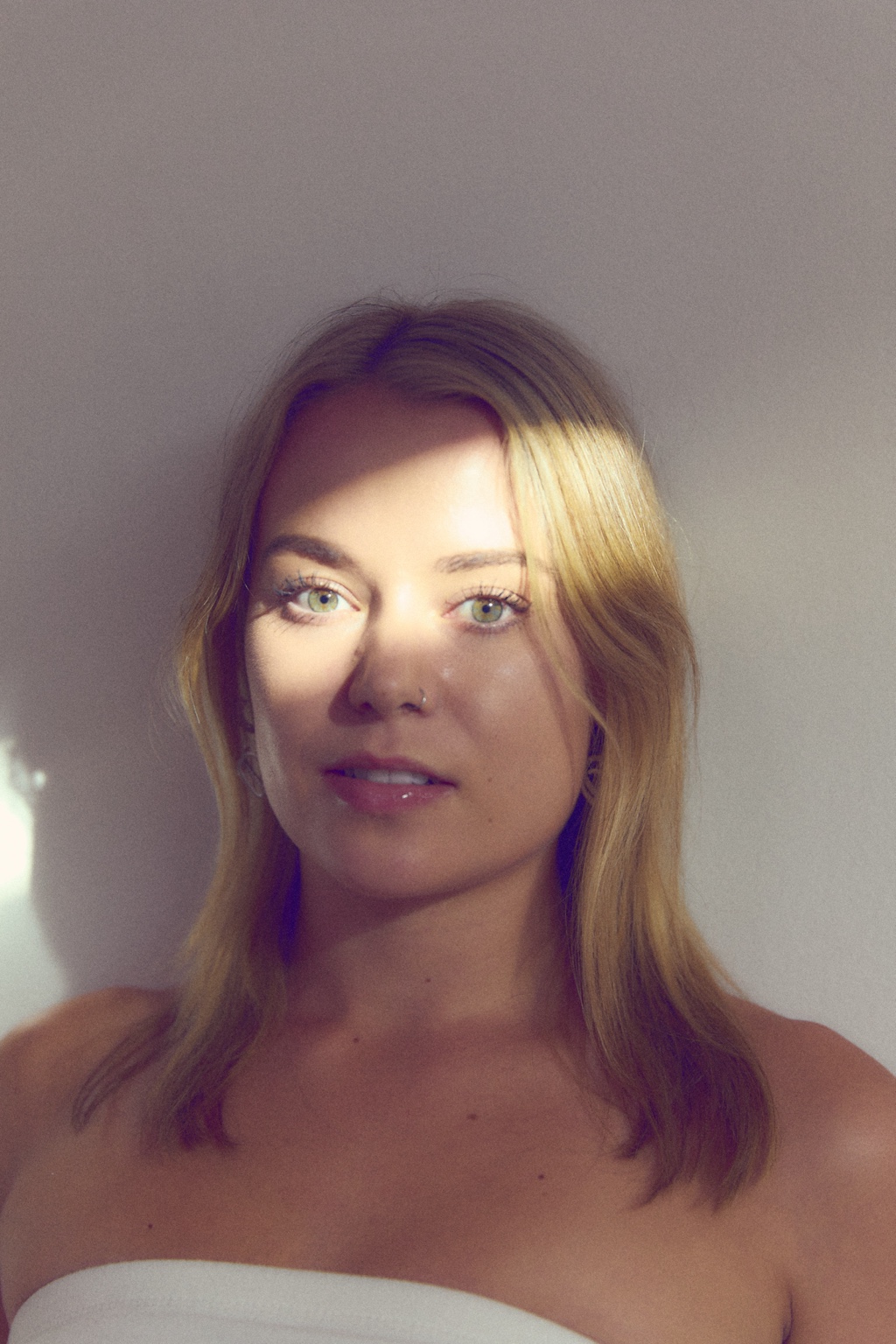 Editorial portrait of Niamh in dramatic sunlight and shadow